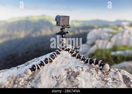 Action camera mounted on a tripod gorilla with summer mountains in the background Stock Photo