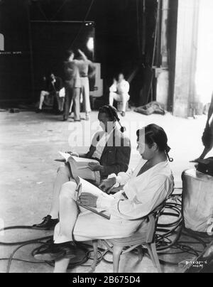 FRANCHOT TONE and CLARK GABLE on set candid on MGM Sound Stage during filming of MUTINY ON THE BOUNTY 1935 director FRANK LLOYD book Charles Nordhoff and James Norman Hall Metro Goldwyn Mayer Stock Photo