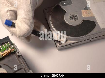 Disassembled hard drive from the computer, hdd with mirror effect. Opened hard drive from the computer hdd with mirror effects. Part of computer pc, l Stock Photo