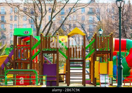 Children's playground as a castle with swings and slides in the park outdoor Stock Photo