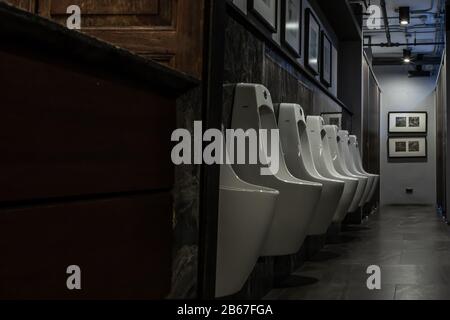 Bangkok, Thailand - Feb 14, 2020 : Public gentlemen toilet restroom. Contemporary interior of public toilet with men urinals. Interior and healthcare Stock Photo