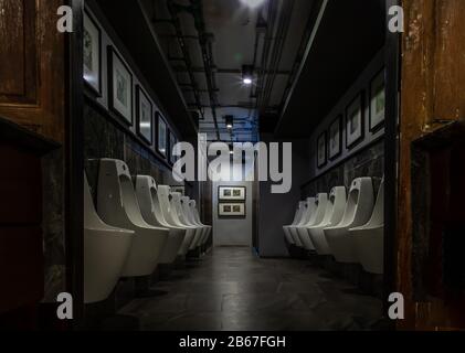 Bangkok, Thailand - Feb 14, 2020 : Public gentlemen toilet restroom. Contemporary interior of public toilet with men urinals. Interior and healthcare Stock Photo