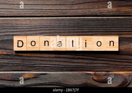 donation word written on wood block. donation text on table, concept. Stock Photo
