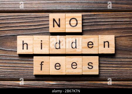 No hidden fees word written on wood block. No hidden fees text on wooden table for your desing, Top view concept. Stock Photo