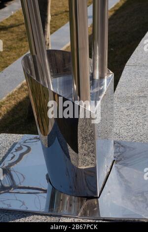 The base of the street lamp on a granite floor made of stainless steel Stock Photo