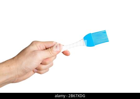 Hand with silicone cooking brush isolated Stock Photo