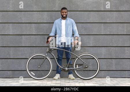 Full length portrait of happy african american man with bicycle Stock Photo