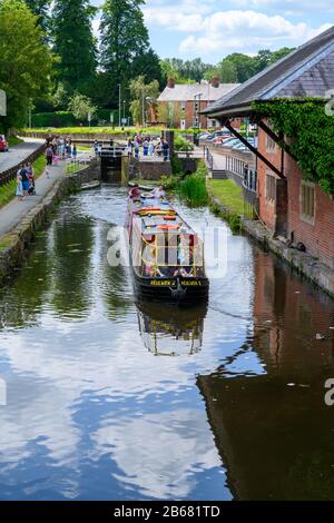 Visitors on a trip boat on the Montgomery Canal in Welshpool during the  Welshpool Transport Festival held in the town in Wales. Stock Photo
