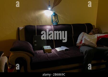 man dozed off on the sofa after a power failure in nairobi. Stock Photo