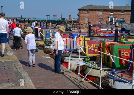 People look at canal boats from around the country at the National Waterways Museum, Ellesmere Port during the annual Easter Boat Gathering. Stock Photo