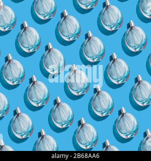 Perfume bottles pattern on blue background Stock Photo