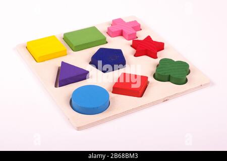 Wooden kindergarten shape puzzle game isolated on the white background Stock Photo