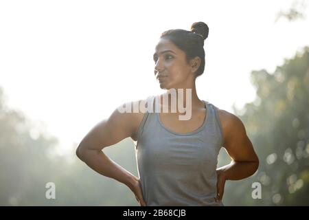 Woman in sportswear looking away at park outdoor Stock Photo
