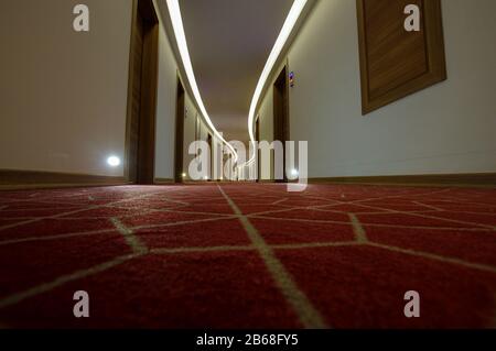 Empty luxury hotel coridor with red carpets, low angle Stock Photo