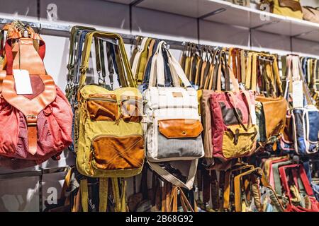 many different stylish vintage backpacks for hipsters stood on a market stand for sale Stock Photo