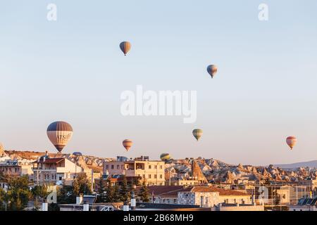 GOREME, CAPPADOCIA, TURKEY - 24 SEPTEMBER 2017: Hot air balloons flying above fantastic scenic landscape of Cappadocia Stock Photo