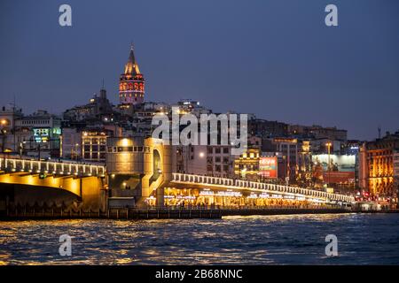 Istanbul landscape at night. Galata Bridge and Galata Tower seaside view Stock Photo