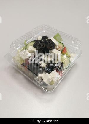 Healthy Greek Salad In Plastic Package For Take Away Or Food Delivery On A  White Marble Background Stock Photo - Download Image Now - iStock