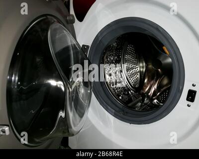 Washing machine drum with many holes internal view Stock Photo