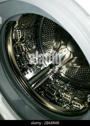 Washing machine drum with many holes internal view Stock Photo