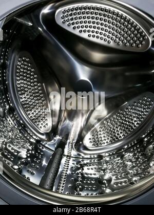 Washing machine drum with many holes internal view Stock Photo