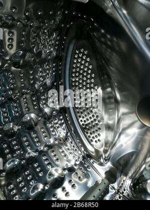 Washing machine drum with many holes internal view Stock Photo