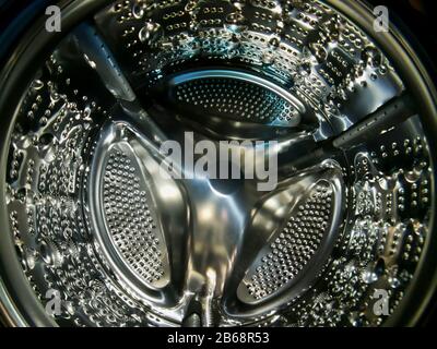 Washing machine drum with many holes internal view Stock Photo