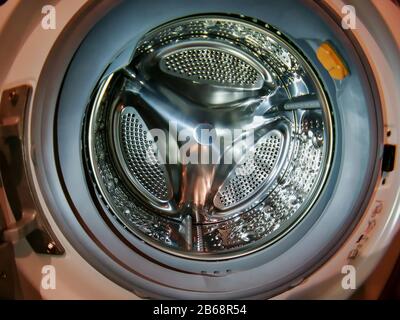 Washing machine drum with many holes internal view Stock Photo