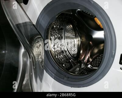 Washing machine drum with many holes internal view Stock Photo