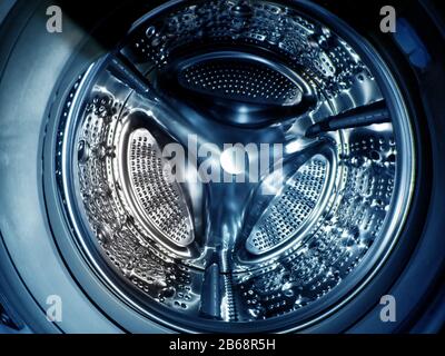 Washing machine drum with many holes internal view Stock Photo