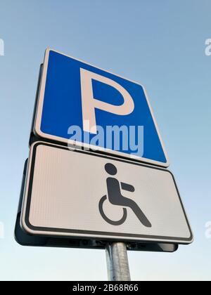 European disabled people parking sign in front of blue sky Stock Photo