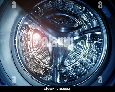 Washing machine drum with many holes internal view Stock Photo