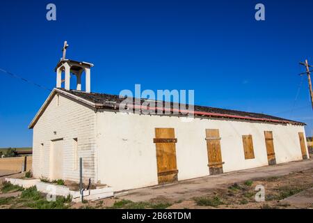 Old Weathered Cross Atop Abandoned Church With Boarded Up Doors Stock Photo