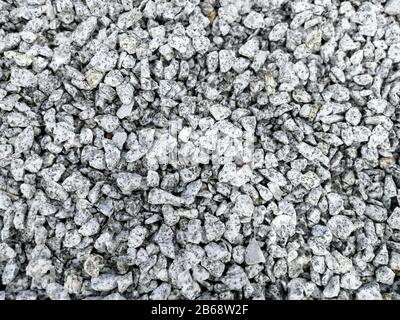 White gray granite break stone or gravel made from crushed rock for decoration abstract background Stock Photo