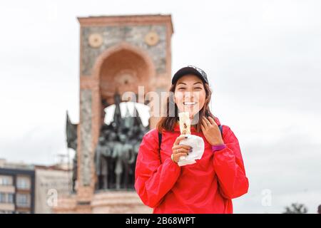 Young woman eating turkish fast food in Istanbul, Turkey Stock Photo