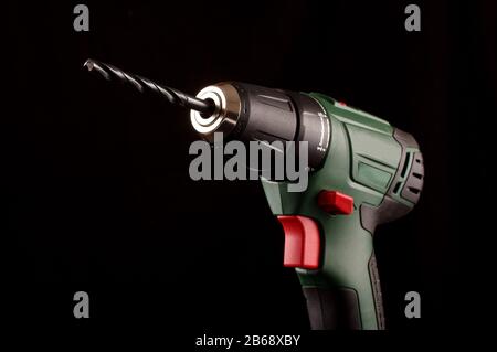 Cordless drill driver isolated on the dark background Stock Photo