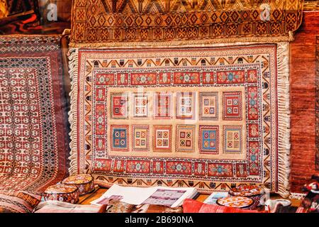 Turkish carpet in the storefront is on sale in the bazaar market Stock Photo