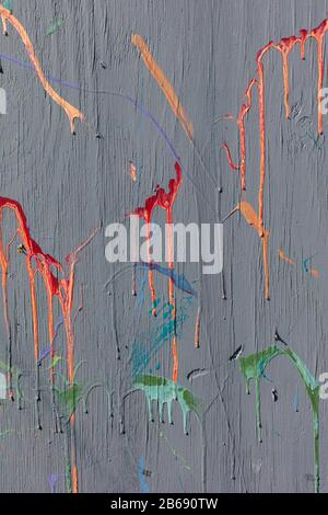 Colorful graffiti paint splattered and dripping on urban wall, close up Stock Photo