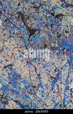Colorful graffiti paint splattered and dripping on urban wall, close up Stock Photo
