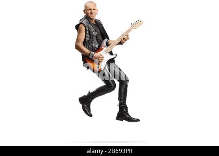 Male musician jumping and playing an electric guitar isolated on white background Stock Photo
