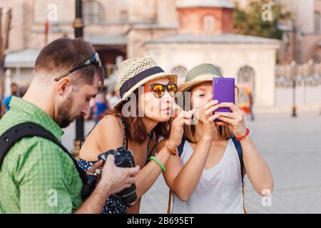 Young friends on a journey making photographs of the city and study mobile photography Stock Photo