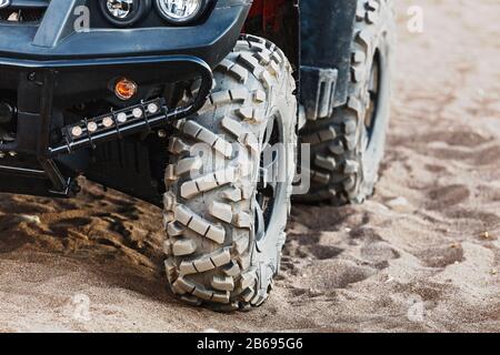 Off-road atv car closeup detail big tire, unrecognizable Stock Photo