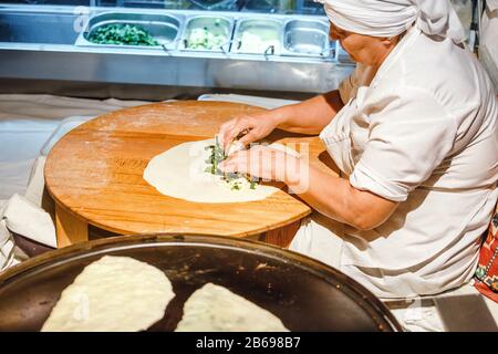 ISTANBUL, TURKEY - SEPTEMBER 10, 2017: Aged woman cooking street food Stock Photo