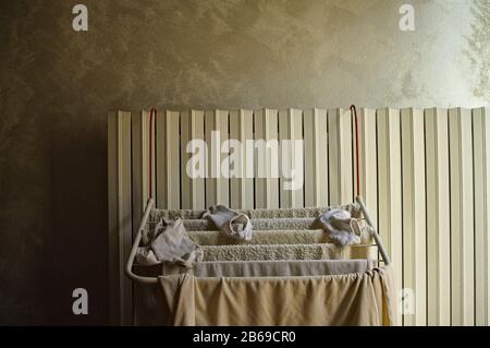Little clotheshorse hanging on the radiator with towels, socks and a t-shirt (Pesaro, Italy, Europe) Stock Photo