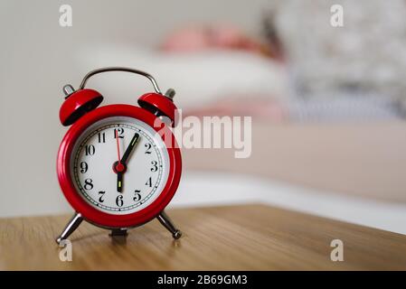 Red old style alarm clock with sleeping man on background Stock Photo