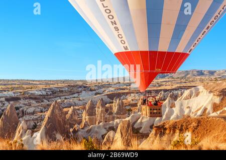 SEPTEMBER 2017, GOREME, CAPPADOCIA, TURKEY: Hot air balloon with tourist in basket flying over rock landscape at Cappadocia Turkey Stock Photo