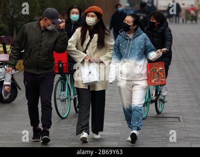 Beijing, China. 10th Mar, 2020. Chinese wear mandatory, protective face masks at an empty, international shopping mall due to the threat of the deadly coronavirus (Covid-19) in Beijing on Tuesday, March 10, 2020. The novel coronavirus has killed more than 4,000 people, with the vast majority in China. There are now more than 113,000 global cases with infections in more than 100 countries over every continent, except Antartica. Photo by Stephen Shaver/UPI Credit: UPI/Alamy Live News Stock Photo
