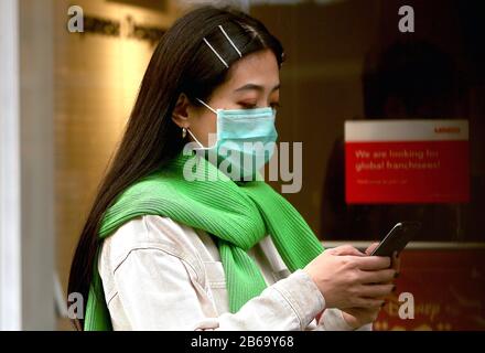 Beijing, China. 10th Mar, 2020. A Chinese woman wears a mandatory, protective face mask at an empty, international shopping mall due to the threat of the deadly coronavirus (Covid-19) in Beijing on Tuesday, March 10, 2020. The novel coronavirus has killed more than 4,000 people, with the vast majority in China. There are now more than 113,000 global cases with infections in more than 100 countries over every continent, except Antartica. Photo by Stephen Shaver/UPI Credit: UPI/Alamy Live News Stock Photo