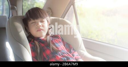 Asian little girl sleeping in car with car seat Stock Photo