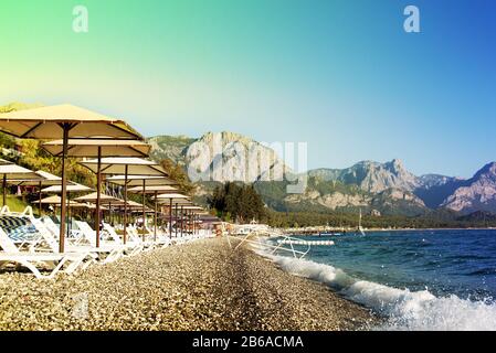 Sunshades and chaise lounges on beach. Summer seascape. Beautiful seaview. Turkey, Kemer.